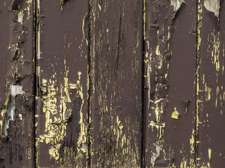 Brown and yellow wooden background with paint breaking off