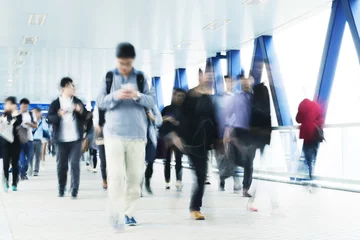 Zelfklevend Fotobehang Hong-Kong Motion blurred commuters in Hong Kong