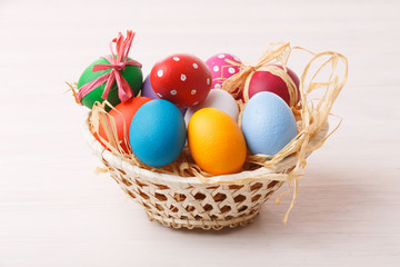 Fototapeta na wymiar Easter eggs in a weaved basket