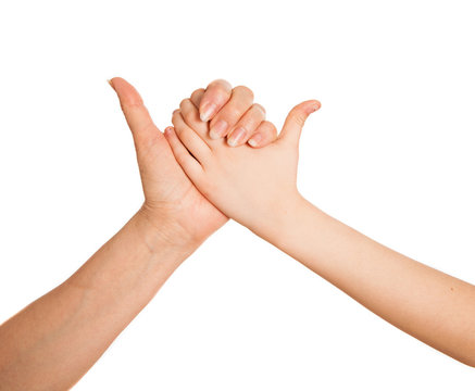 Adult's hand and child's hand holding together