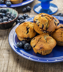 Homemade muffins with blueberries on a wooden background