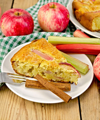 Pie with apple and rhubarb in plate on board