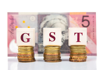 GST concept with stack of coins and Australian Dollar