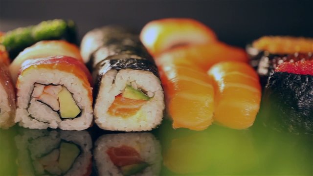 Delicious sushi pieces in row