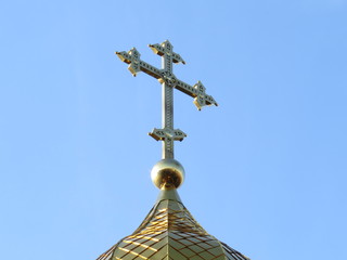 The cross on the top of the dome of an Orthodox church.