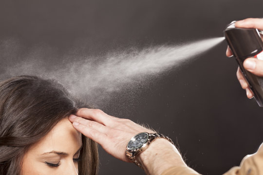 Hairdresser Apply Hairspray On His Client's Hair