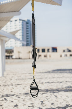 Training straps hanging on a shed at the beach