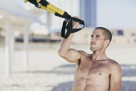 Young male athlete working out at the beach