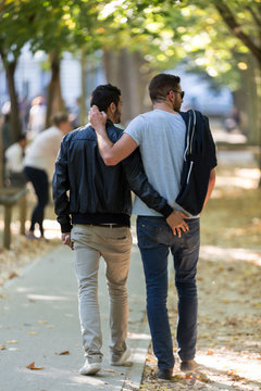 Gay couple relax in Luxembourg Gardens in Paris