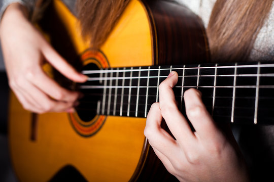 Woman playing accoustic guitar