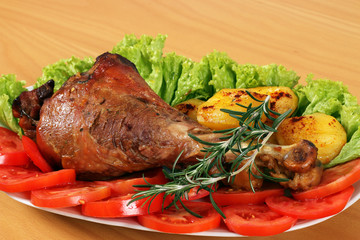 drumstick with vegetables on plate