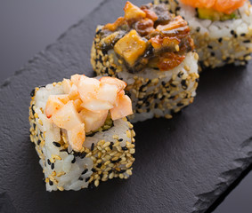 Sushi rolls on a stone plate