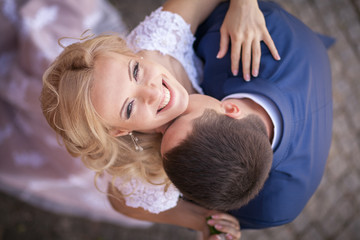 groom embraces the bride