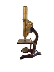 Old vintage microscope isolated over white