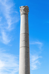 One ancient column on blue sky background