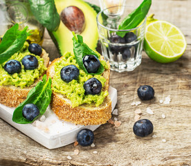 Sandwiches with avocado, blueberries and spinach