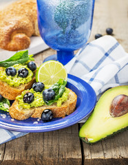 Toasts with blueberry and avocado cream