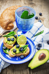 Toasts with blueberry and avocado cream