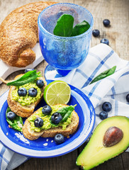 Toasts with blueberry and avocado cream