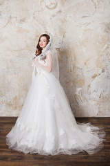 Slim beautiful woman with long hair wearing luxurious wedding