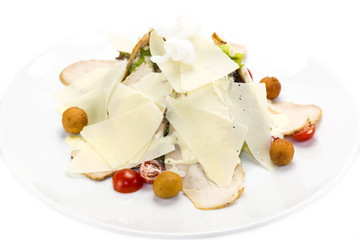 caesar salad on a white plate in a restaurant