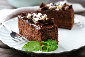 Tasty pieces of chocolate cake with mint