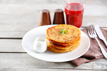 Stack of corn tortillas with stuffing and glass of juice