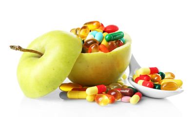 Apple and colorful pills, isolated on white