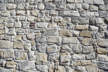 old gray stone wall of brick