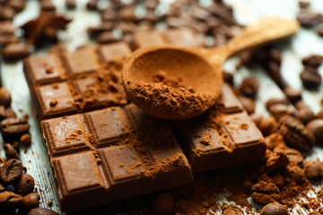 Still life with chocolate, grains and cocoa on wooden