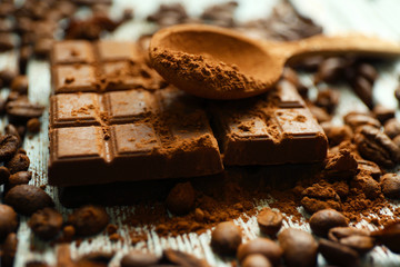 Still life with chocolate, grains and cocoa on wooden