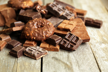 Set of chocolate on wooden table, closeup