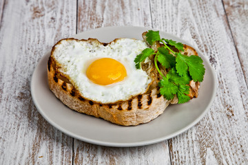 Eggplant crostini on a wight wood background.