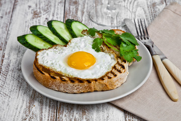 Eggplant crostini on a wight wood background.