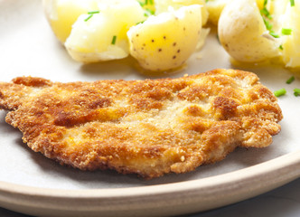 fried pork fillet with boiled unpeeled potatoes