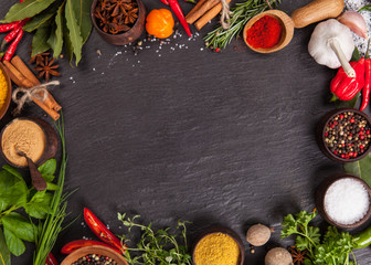 Various spices on black stone