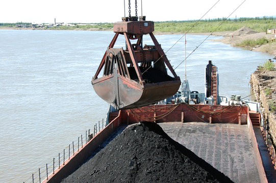 Slackline cableway bucket with coal at river port