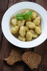 Close-up of gnocchi with pesto sauce in a plate, studio shot