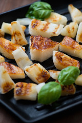 Close-up of chopped and barbecued pineapple with basil