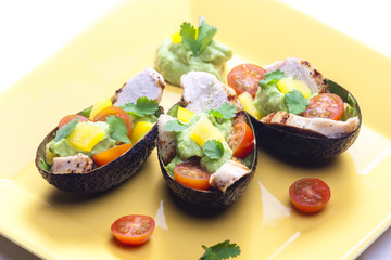 avocado filled with chicken salad and avocado dip