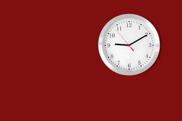 classic clock on red background with copy-space