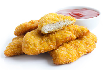 Golden fried chicken strips on white. With dish of ketchup.