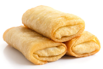 Fried chinese spring rolls on white surface.