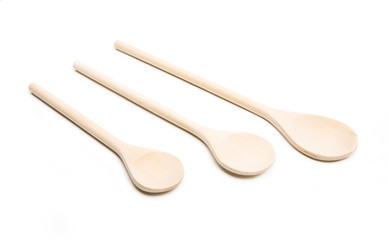 Three wooden spoons isolated at white
