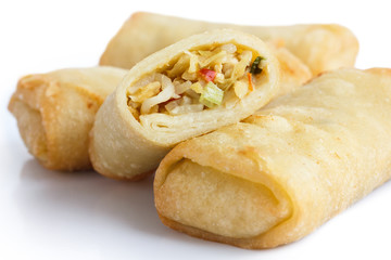 Fried chinese vegetable spring rolls on white surface.