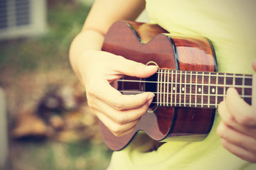 Woman playing ukulele, vintage style.