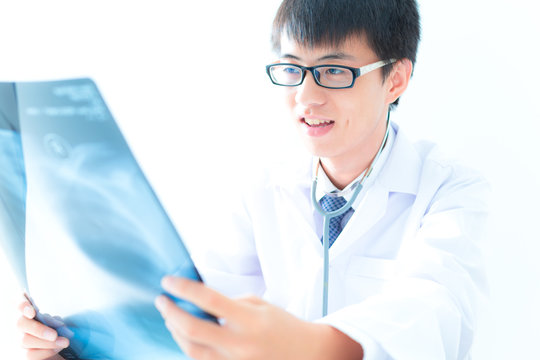 close up of male doctor holding x-ray or roentgen image