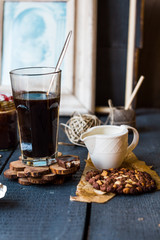 Black coffee cup with biscuits and chocolate