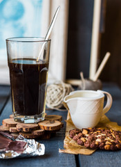 Black coffee cup with biscuits and chocolate