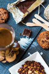 coffee with milk in a glass with biscuits and chocolates, a top